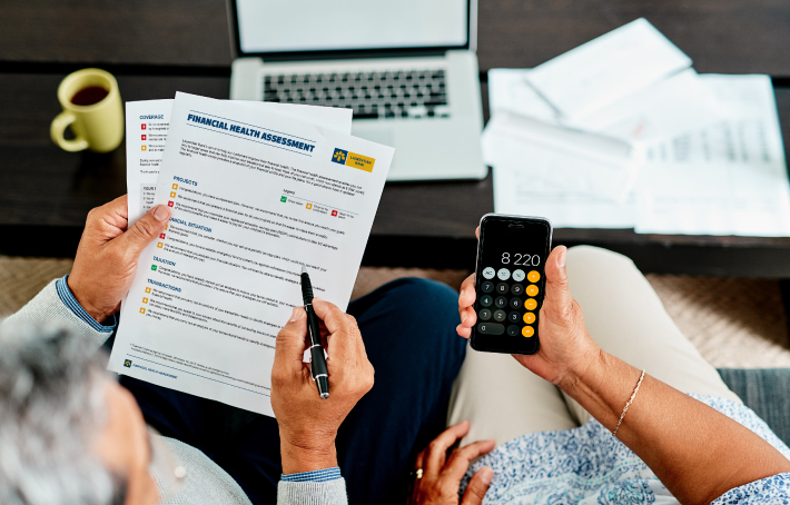 decorative image: a man and woman looking over financial documents